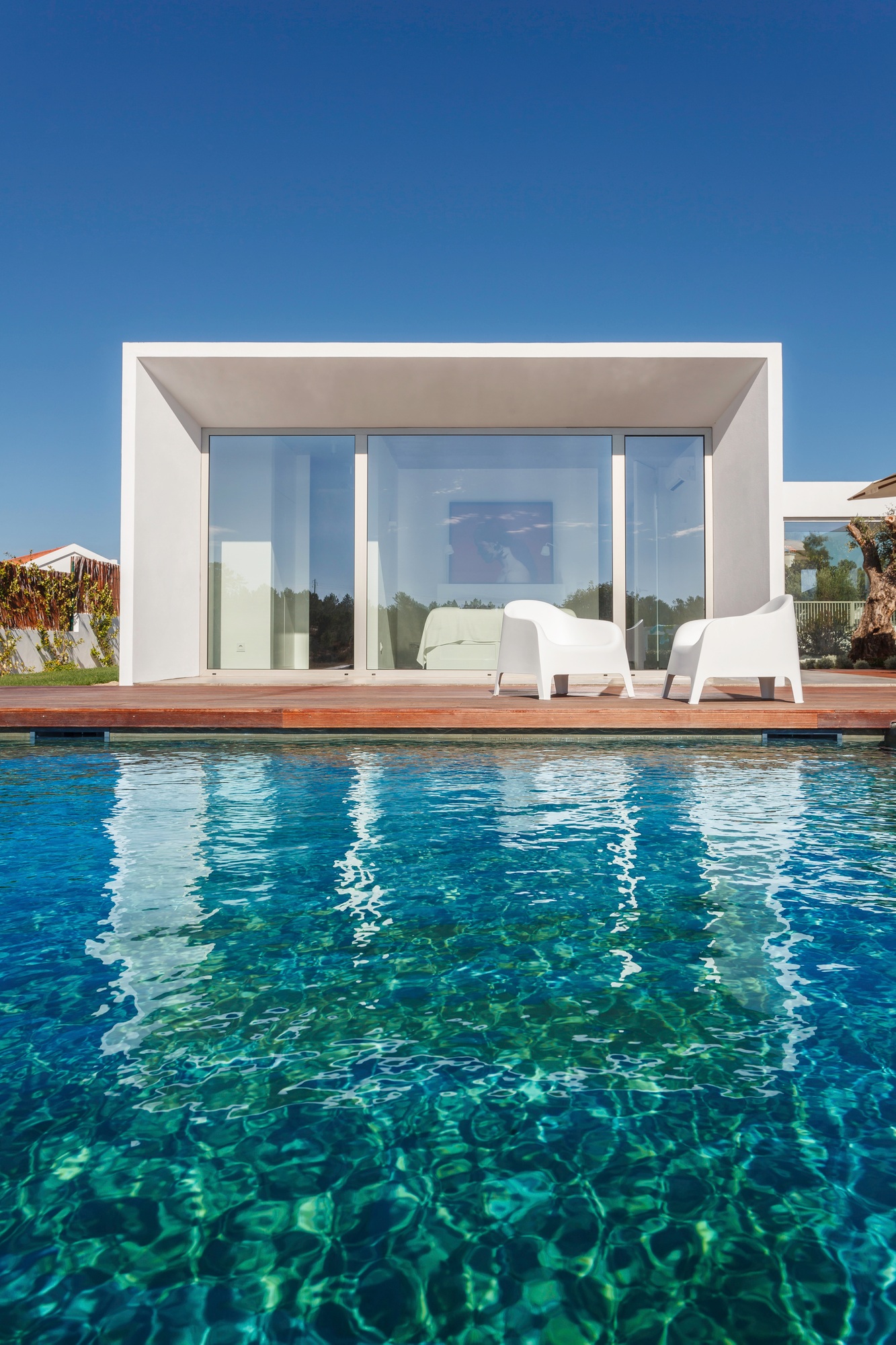 Modern house with garden swimming pool and wooden deck